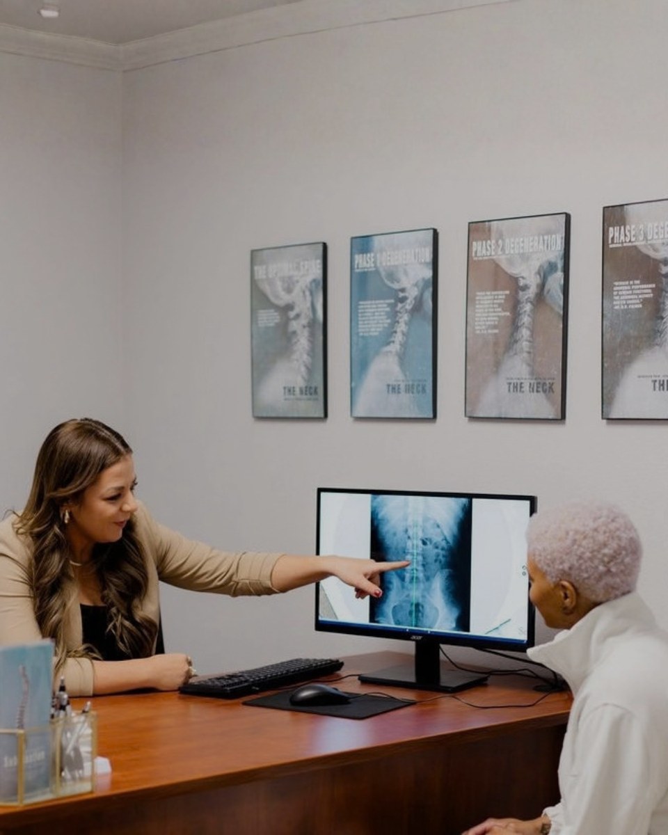 A doctor walking a patient through spinal x-rays