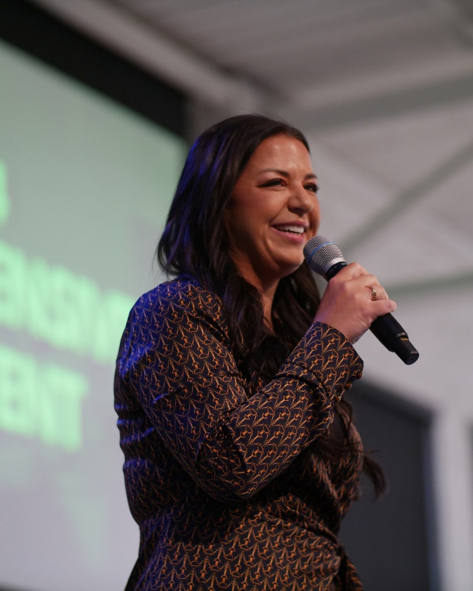 Dr. Elise speaking on stage at a ChiroIntensive live event