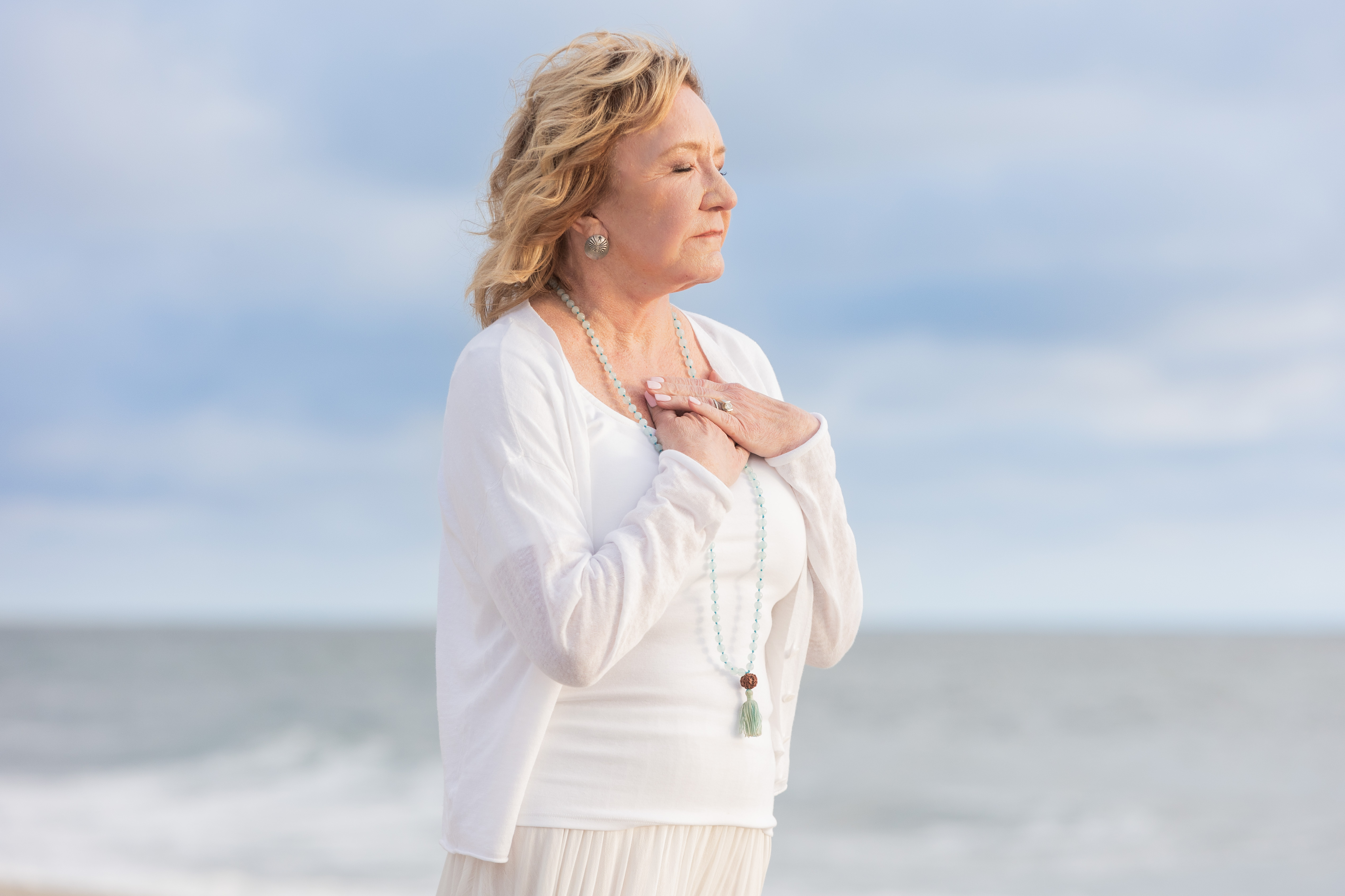 Deb at the shore, hands on heart