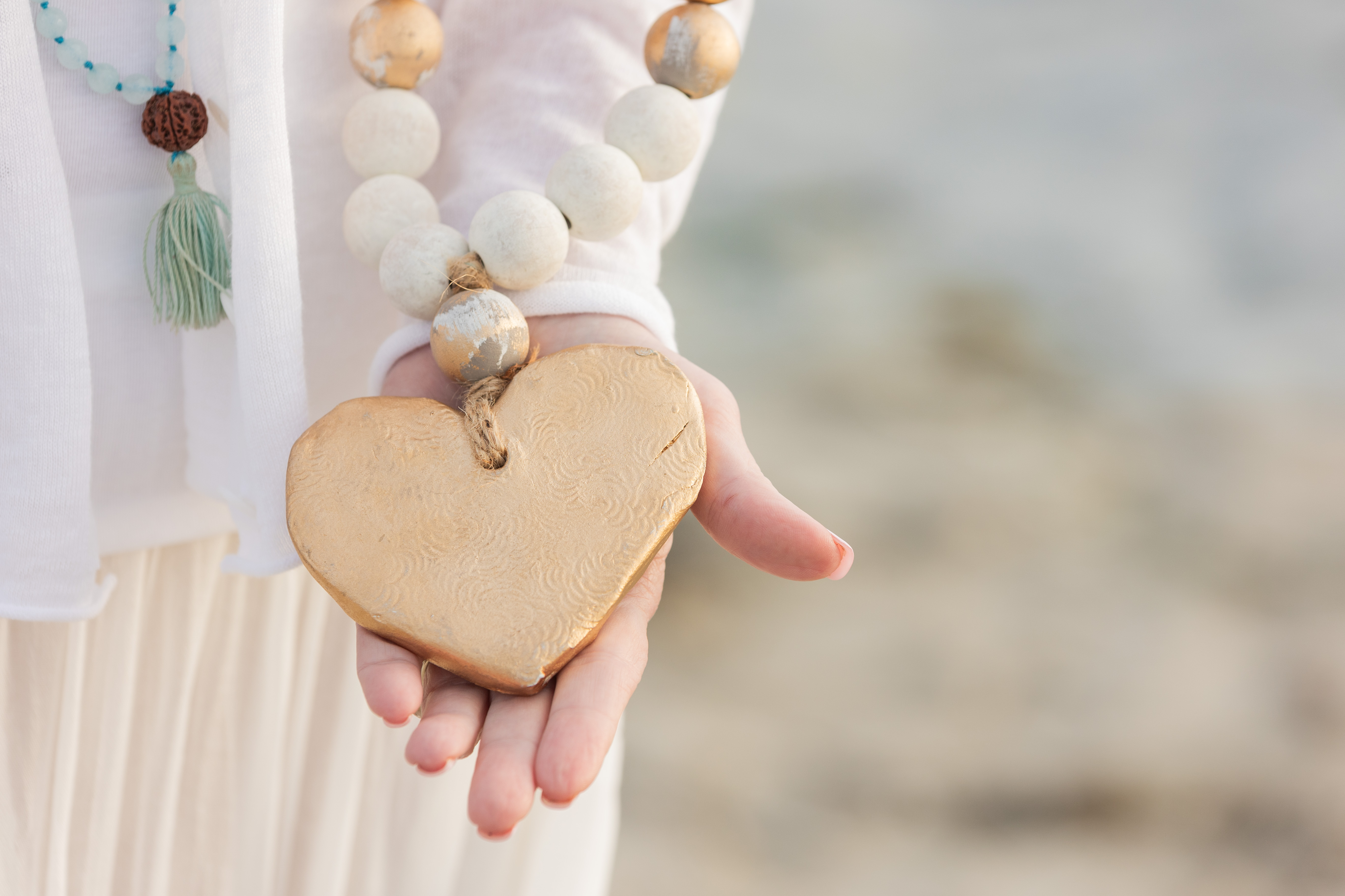 gold heart in open hand
