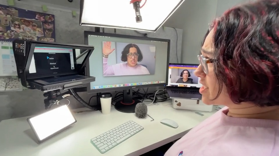A client reviewing her take on the studio monitor
