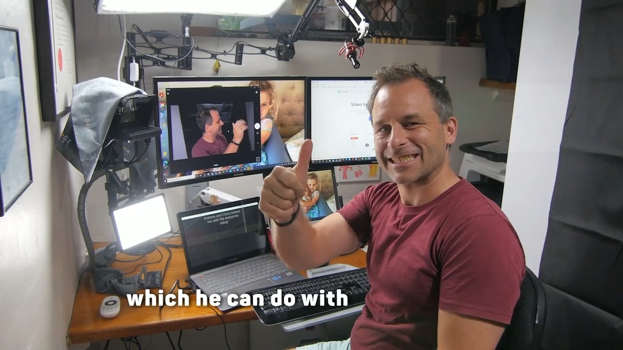 A client giving a thumbs up at his dual-monitor studio desk