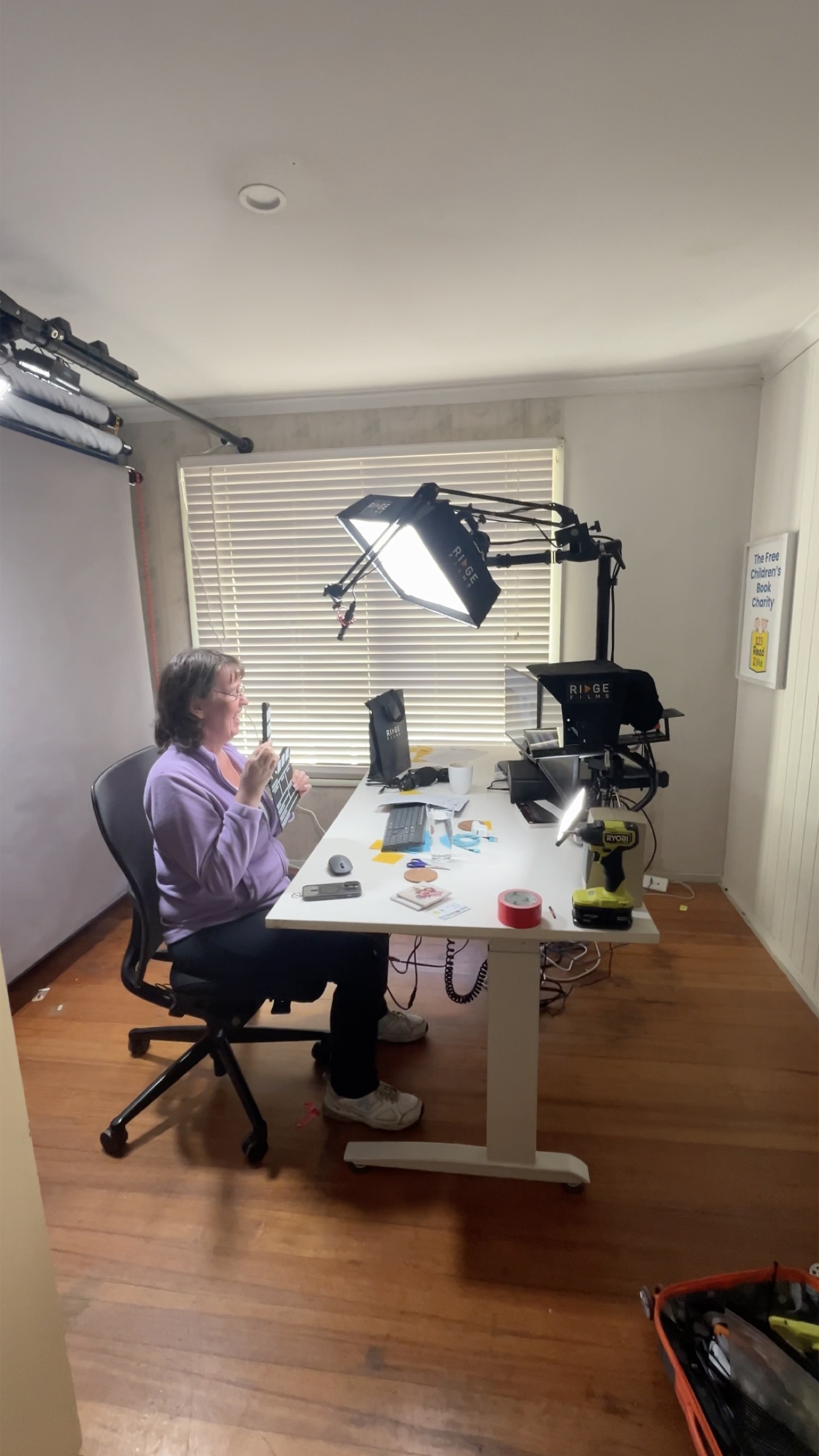 A client laughing while holding the clapperboard before a take