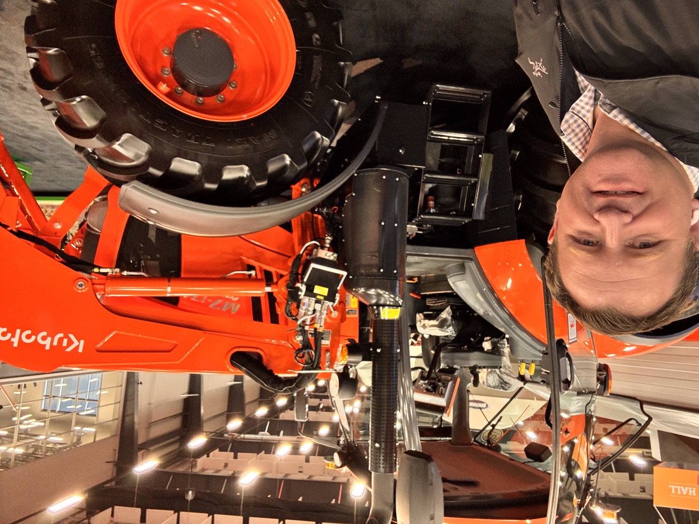 Beside a Kubota tractor and loader.
