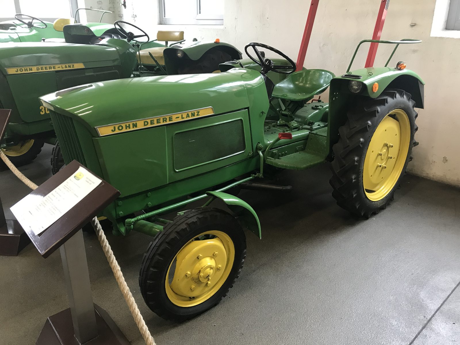 A classic John Deere-Lanz tractor in a historic equipment collection.