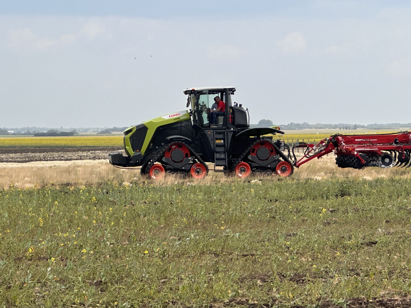 A field demonstration featuring CLAAS and HORSCH equipment.