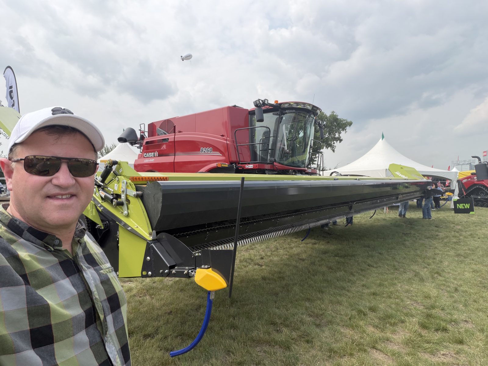 A Case IH 8260 combine with a wide harvesting header.