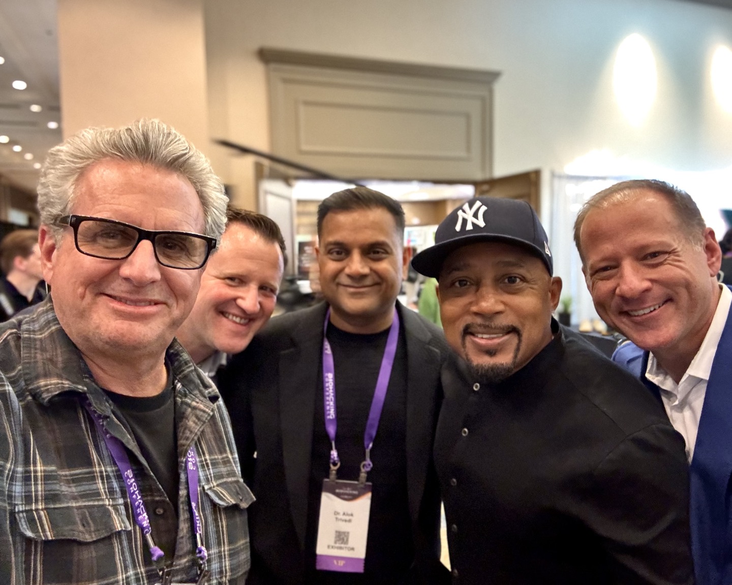 A group photo including Troy Aberle, Alan Taylor, and Daymond John