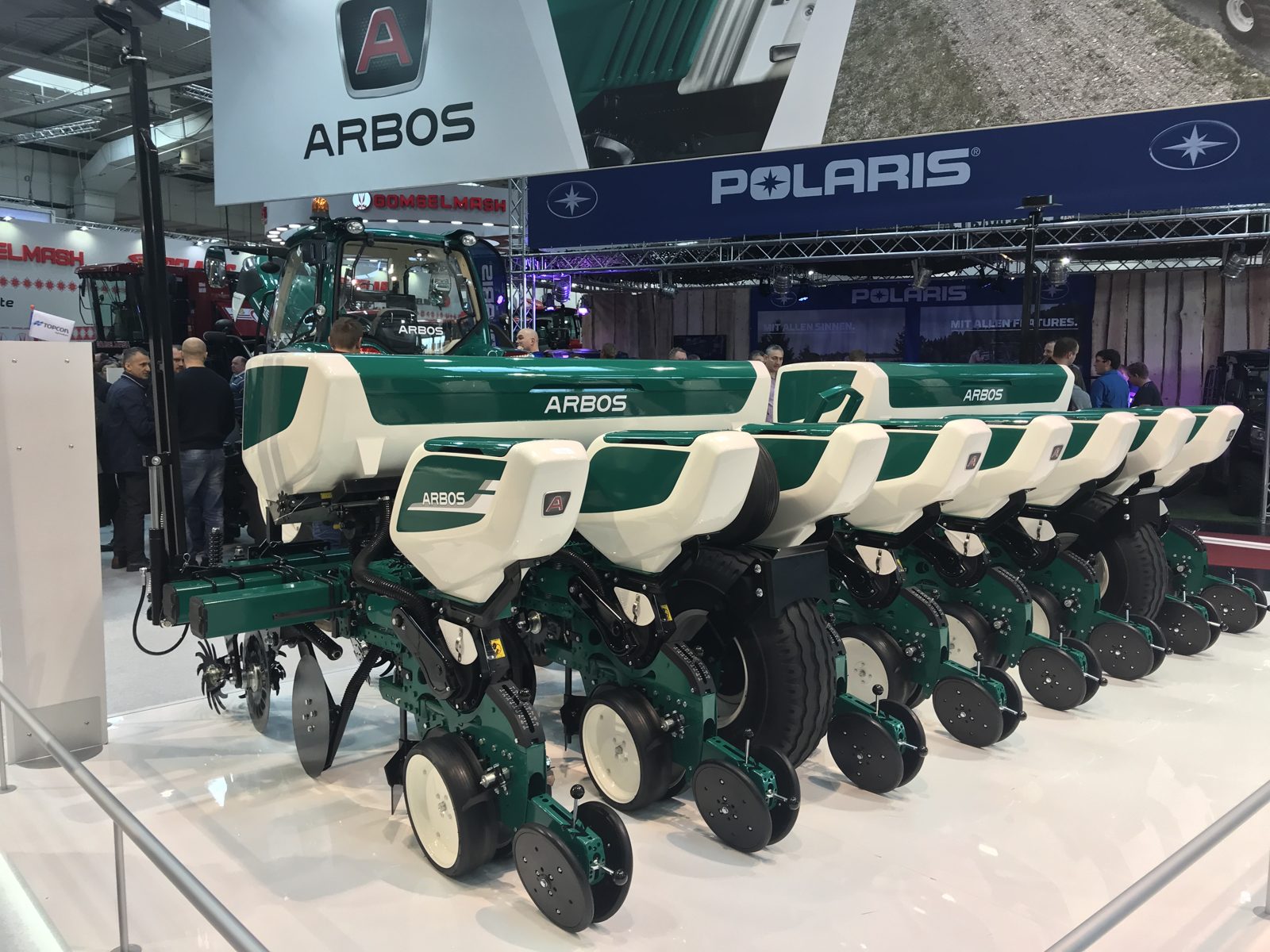 A row-crop planter with individual seed units on display.