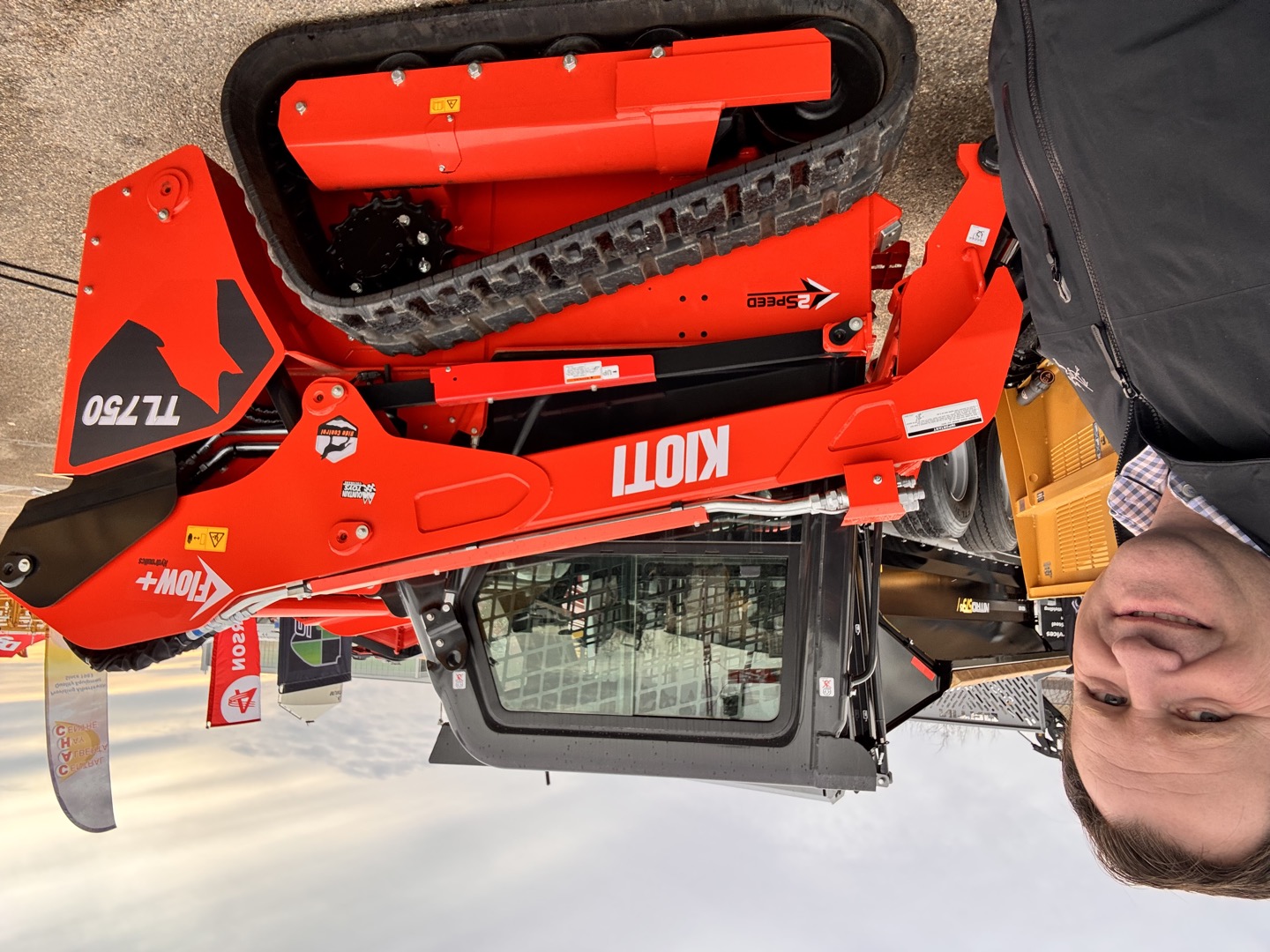 Beside the KIOTI TL750 compact track loader.