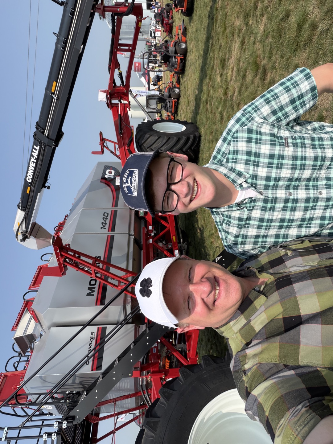A moment together beside the equipment, with Convey-All overhead.
