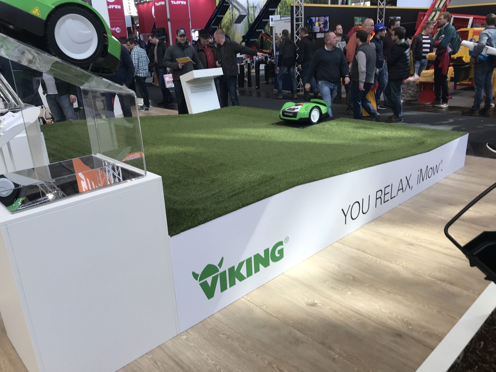 A robotic lawn mower on a demonstration turf display.