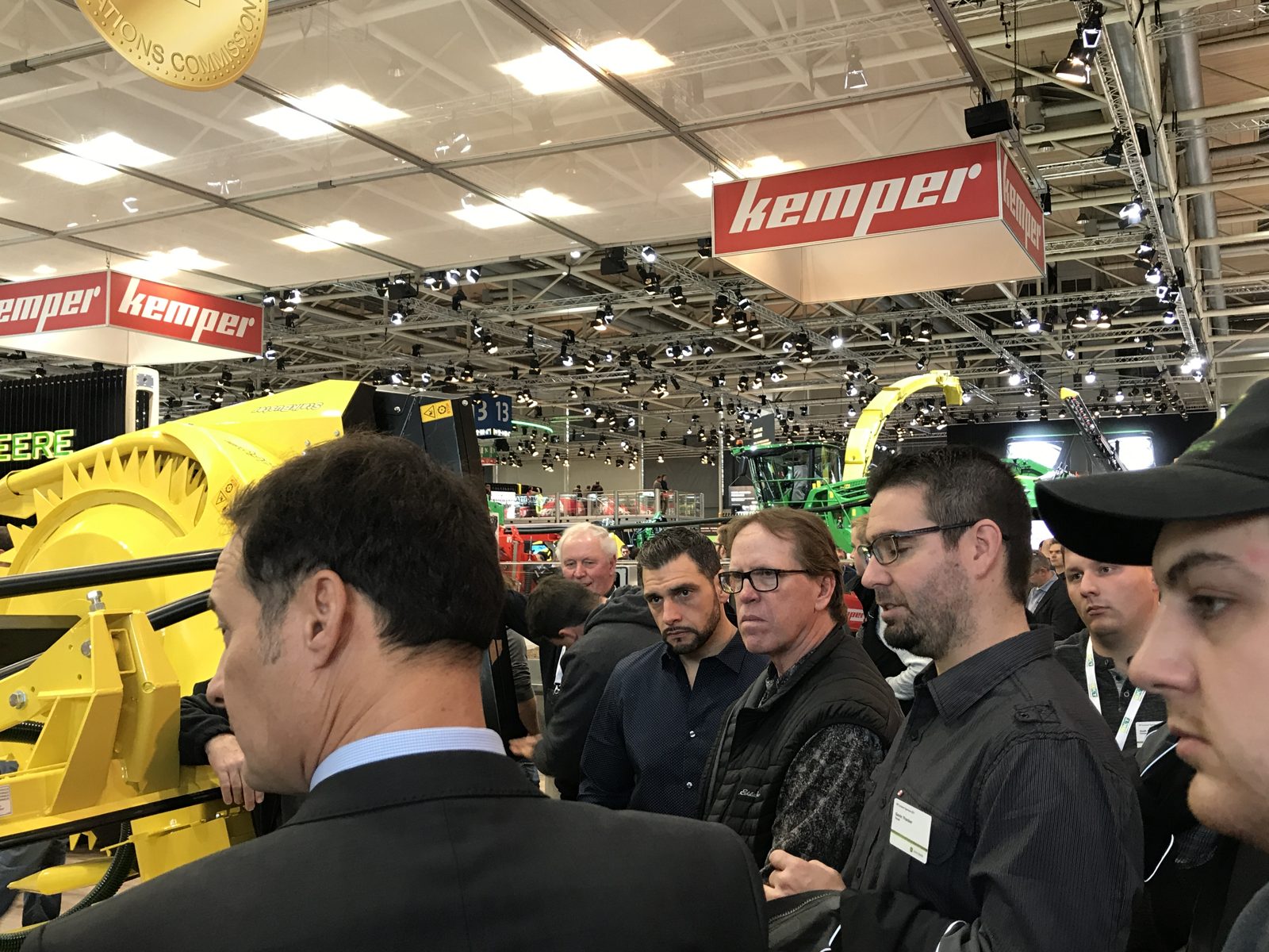 A group taking a closer look at harvesting equipment at the Kemper exhibit.