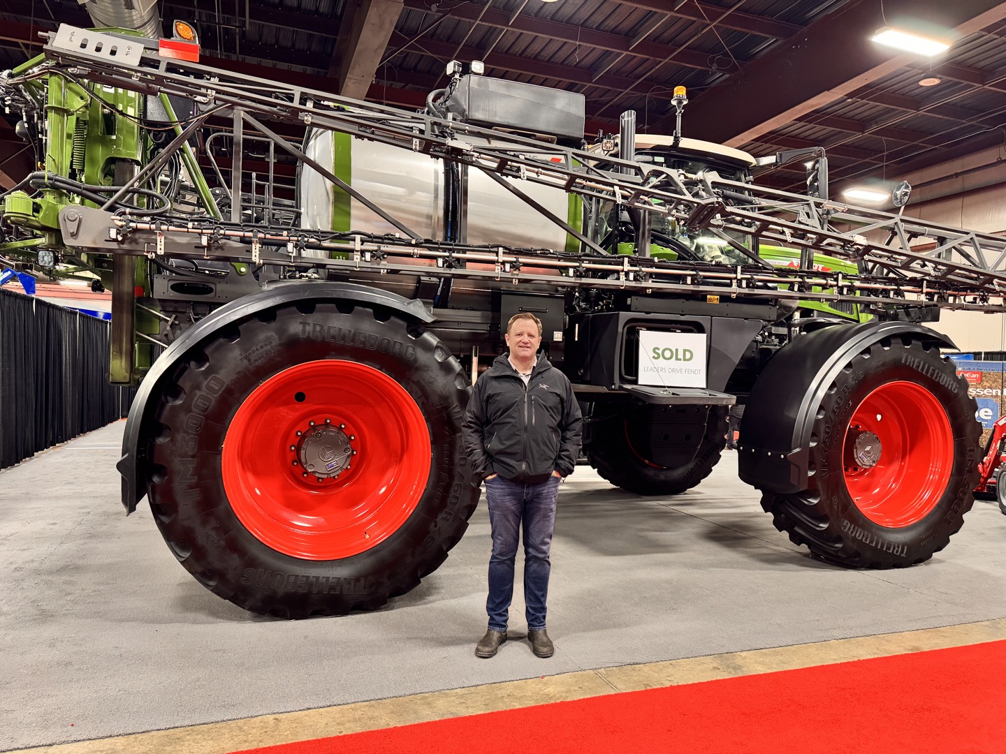 Beside a Fendt sprayer at Agri-Trade in Red Deer, Alberta