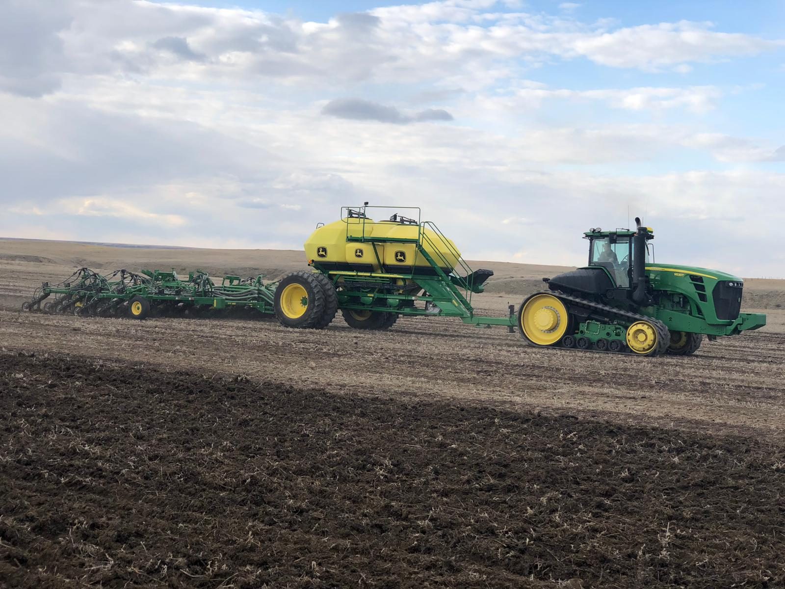 A two-track John Deere 9530T tractor during seeding.