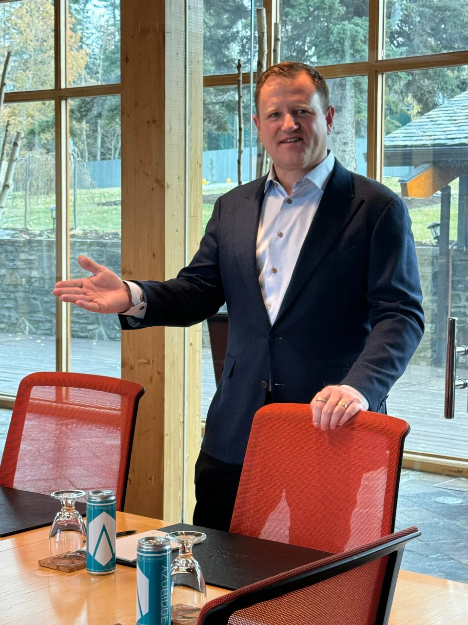 Troy Aberle beside a conference table