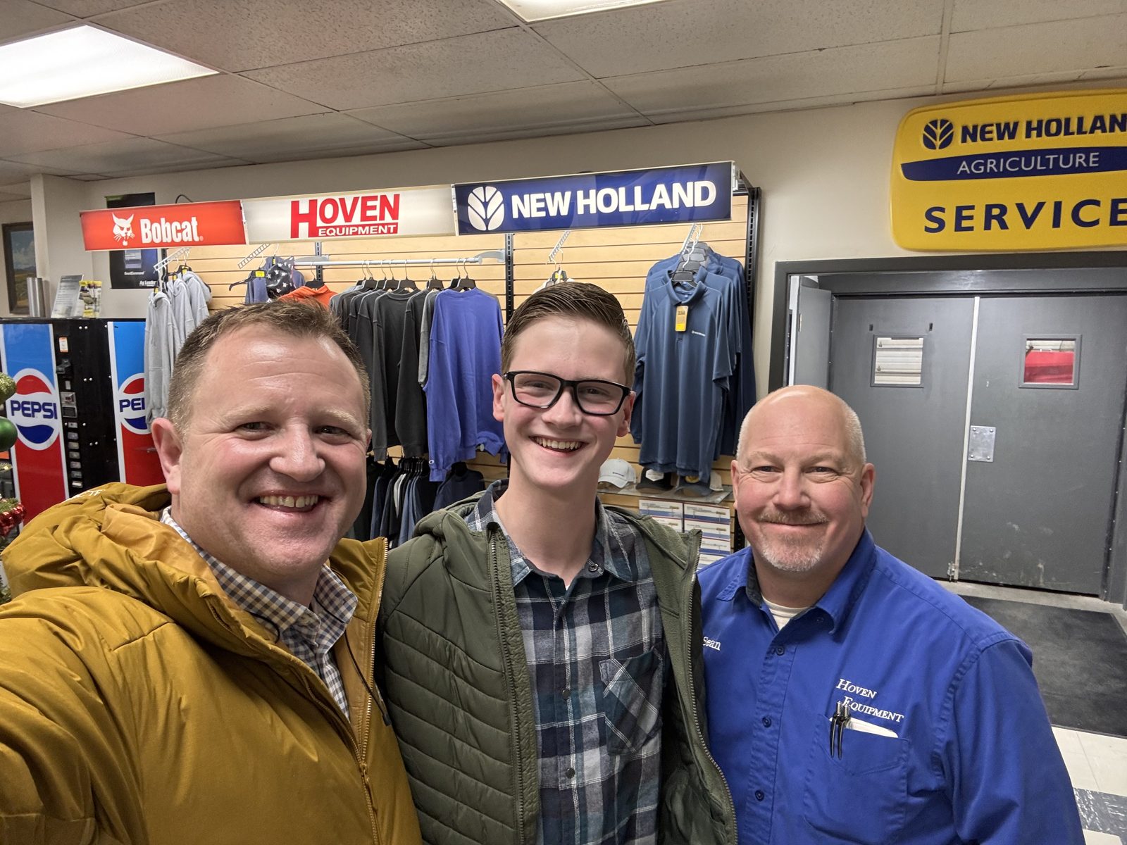 A dealership visit with New Holland and Bobcat signs on display.