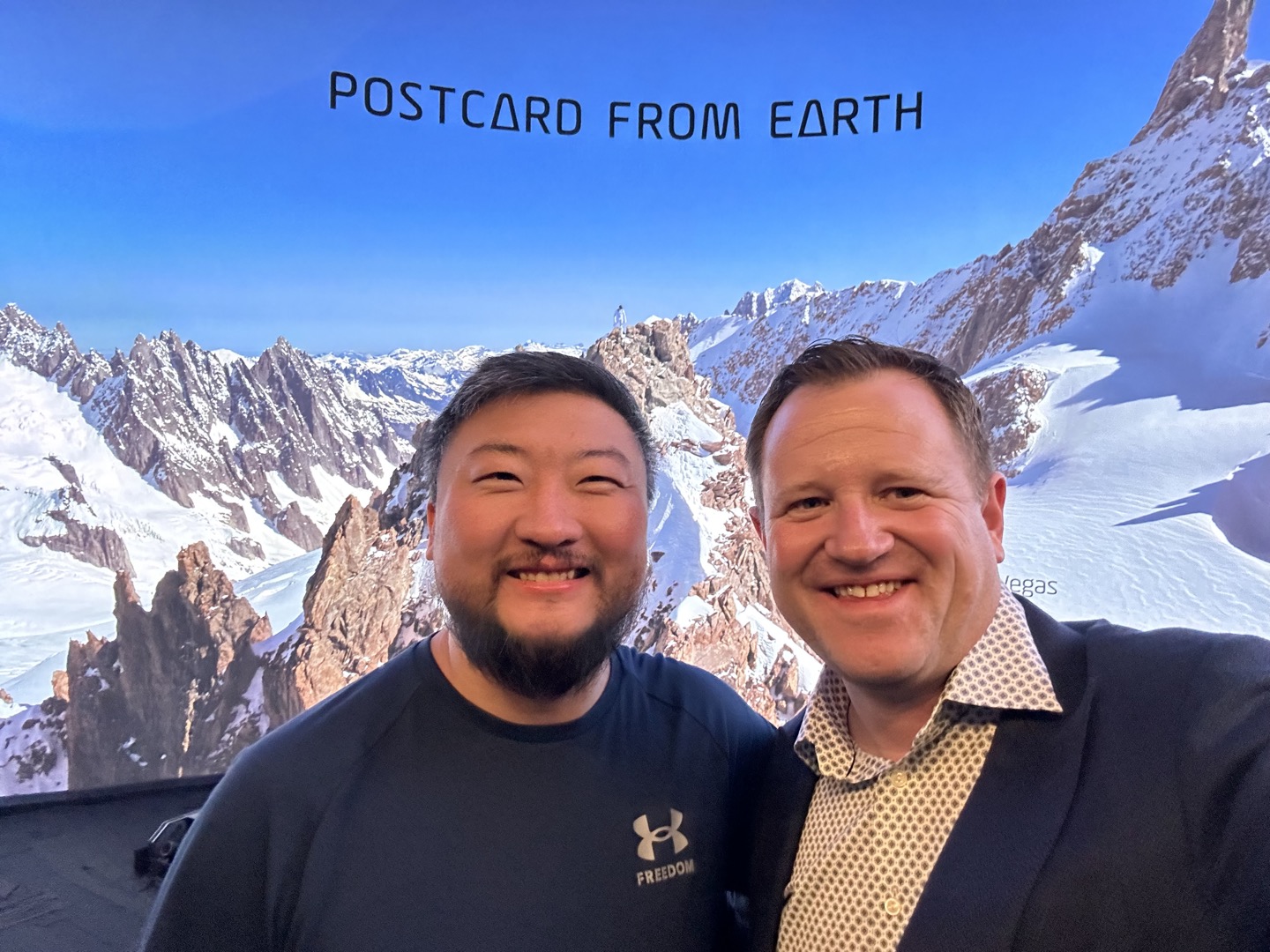 A photo in front of a Postcard from Earth display during the trip.