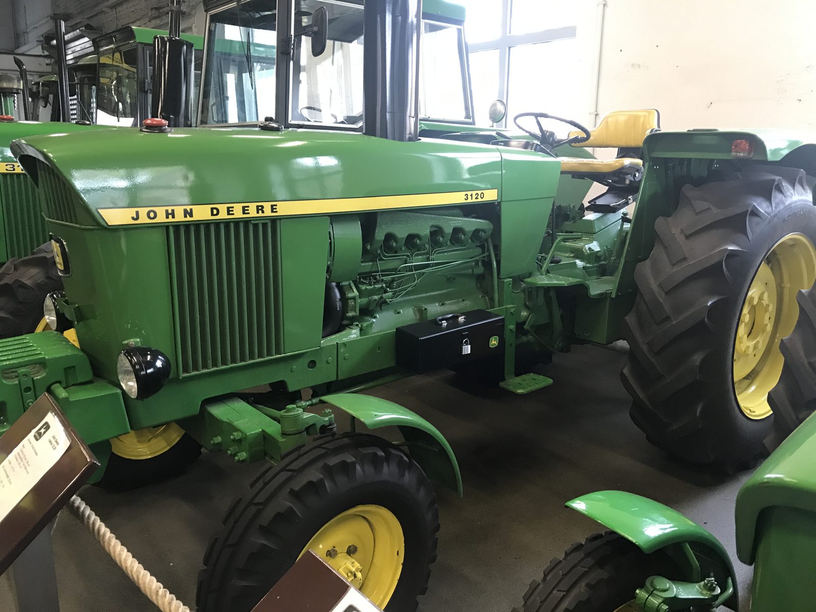 A classic John Deere 3120 tractor with an open operator station.