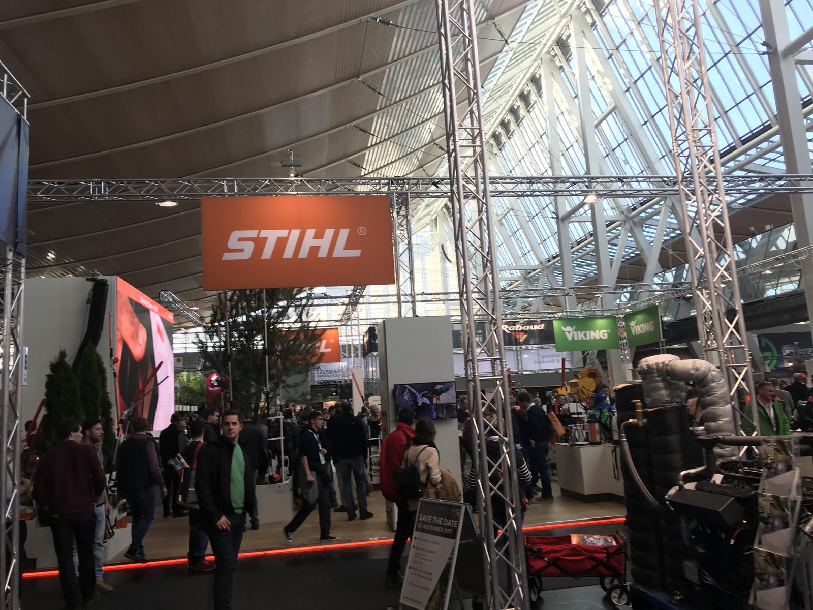 Outdoor power equipment exhibits at a busy trade show.