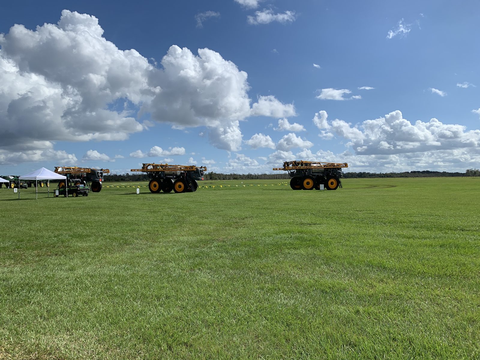 High-clearance Hagie sprayers at an equipment demonstration.