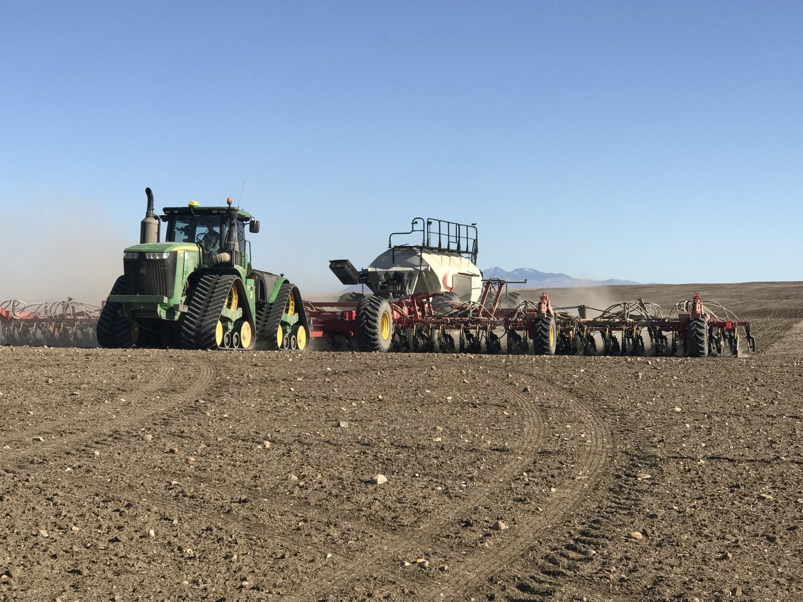 A four-track tractor and air-seeding system in the field.