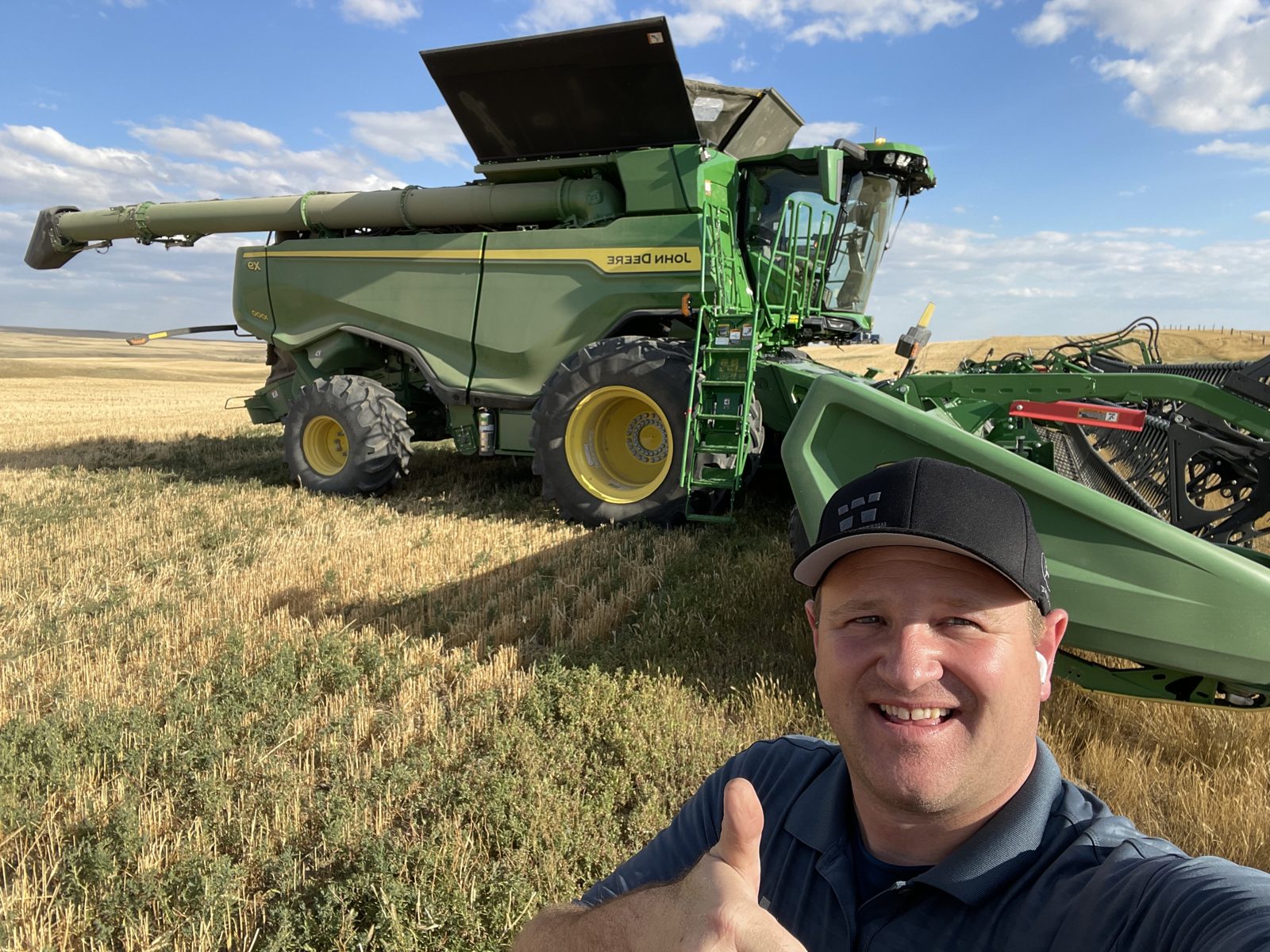 A moment beside a John Deere X9 combine.