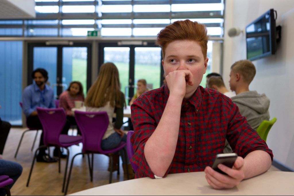 Student struggling to focus in a classroom, a common sign of ADHD