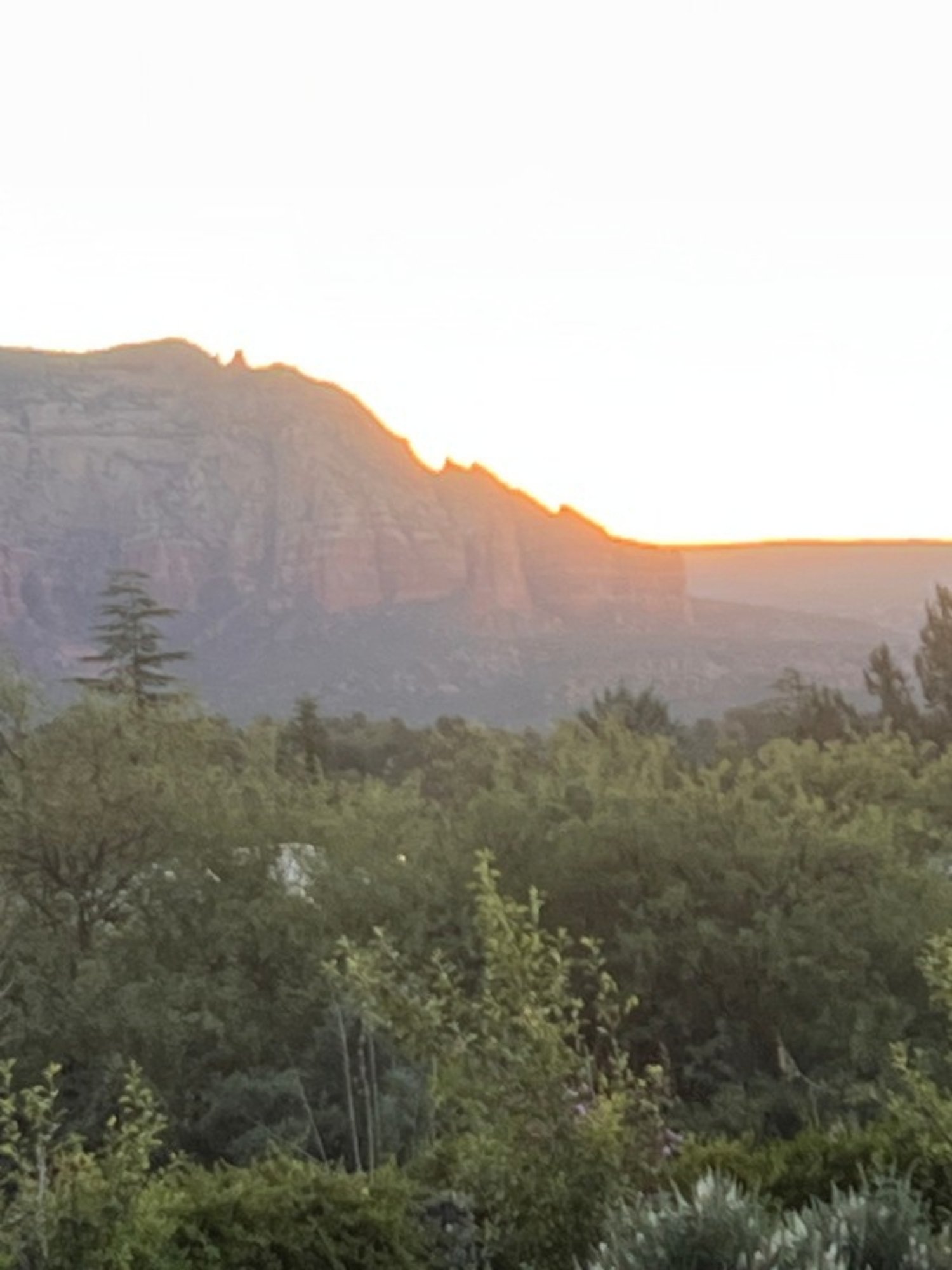 Sunset glowing over a red rock ridge in Sedona