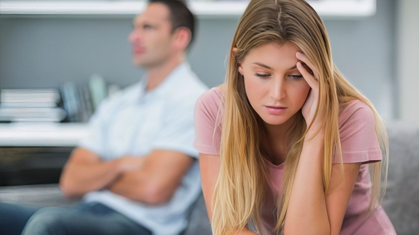 A woman sitting apart from her partner, wondering whether he can change