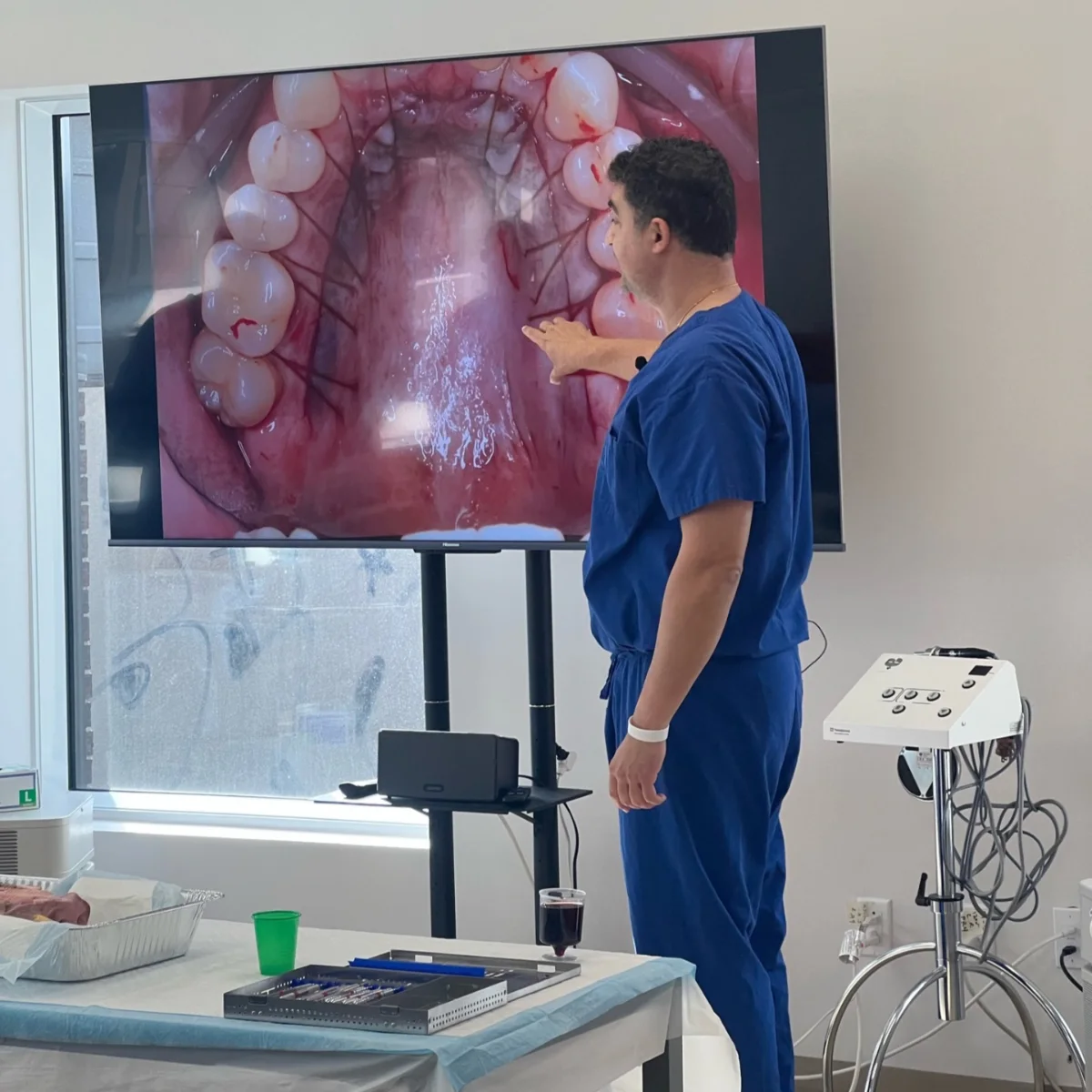 Zeeba periodontist demonstrating a soft tissue grafting technique on screen during a live hands-on workshop