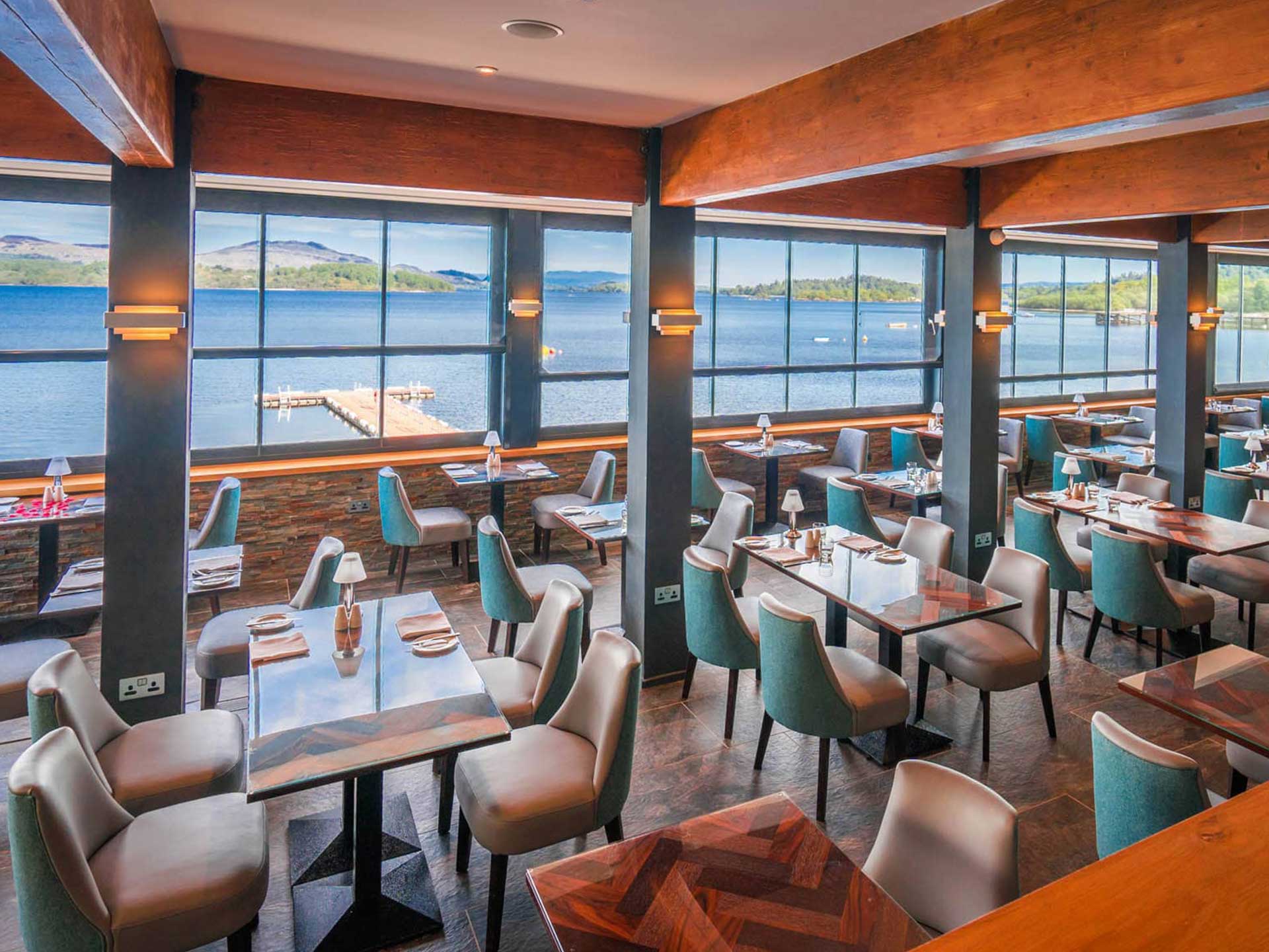 The lodge restaurant with tall windows over the water