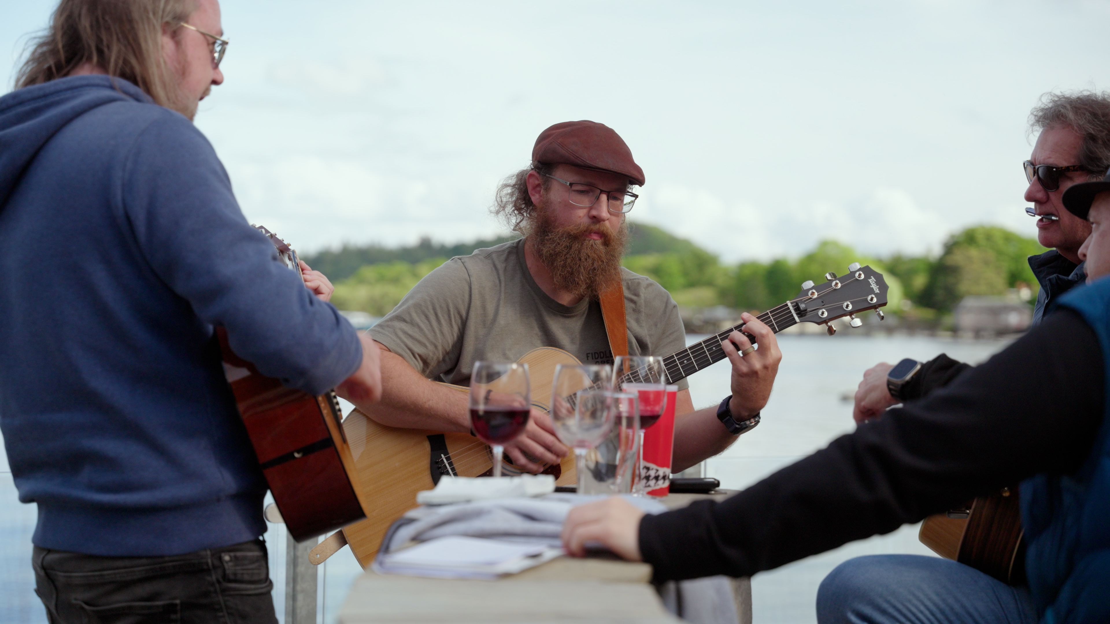 Guitarists jamming on the terrace beside the loch