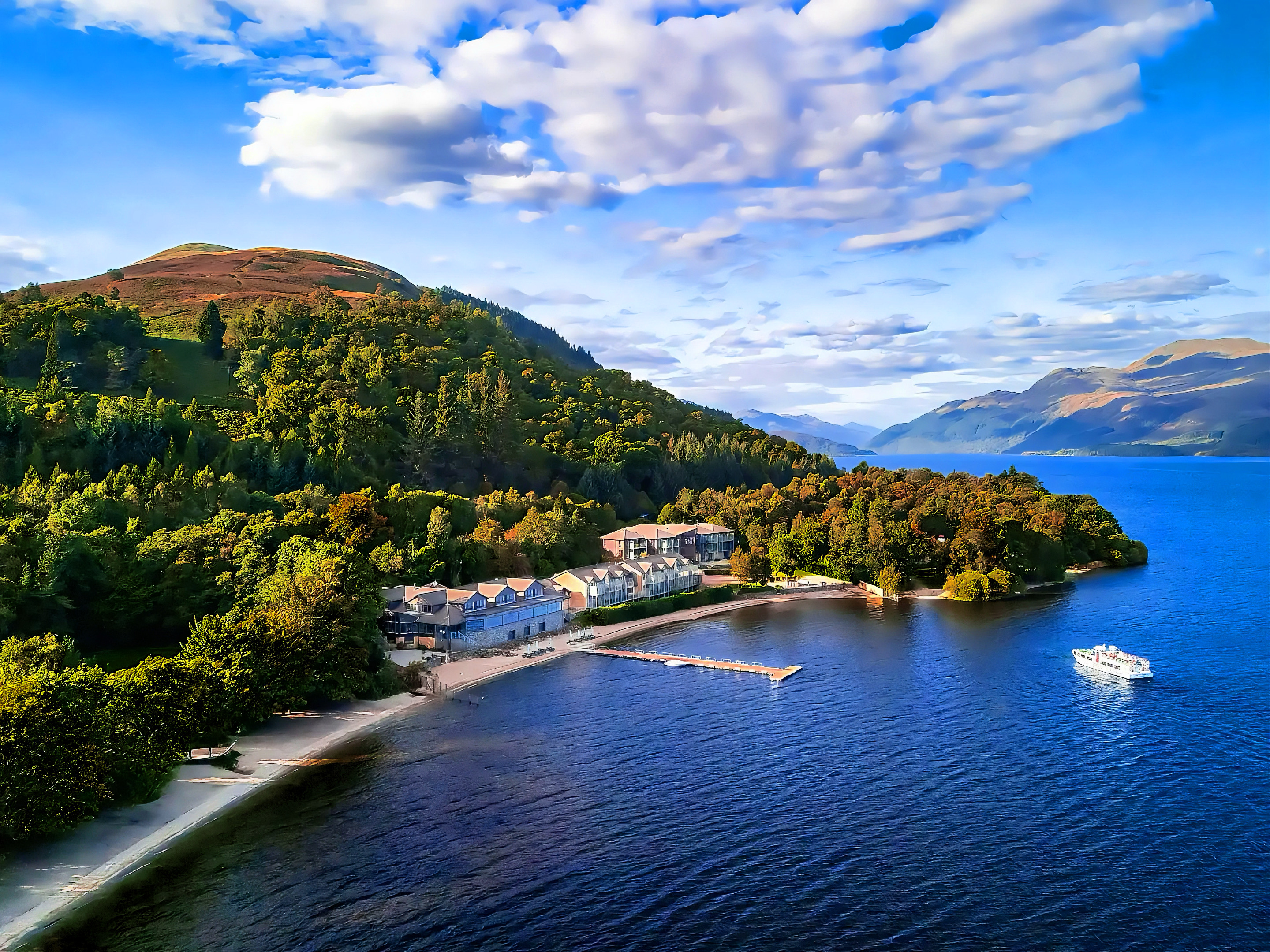 The Lodge on Loch Lomond at dusk, its windows glowing beside the loch