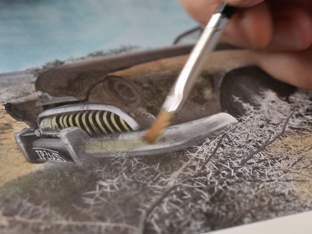Hand painting onto a photographic print with a fine brush, an art photography technique