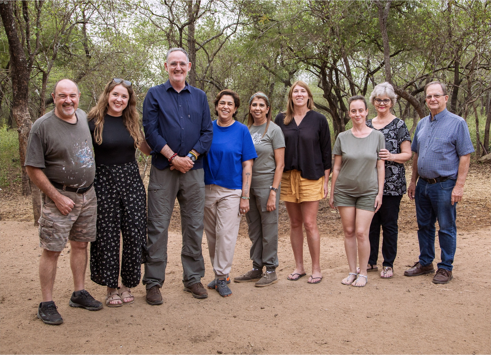 The first May 2026 group standing together under the trees at the guesthouse