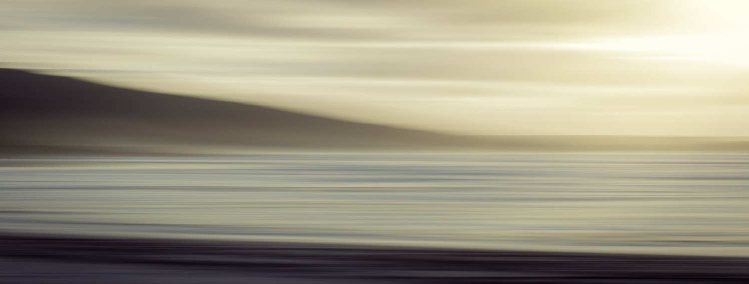 Wide abstract shoreline in warm bands of cream and deep plum