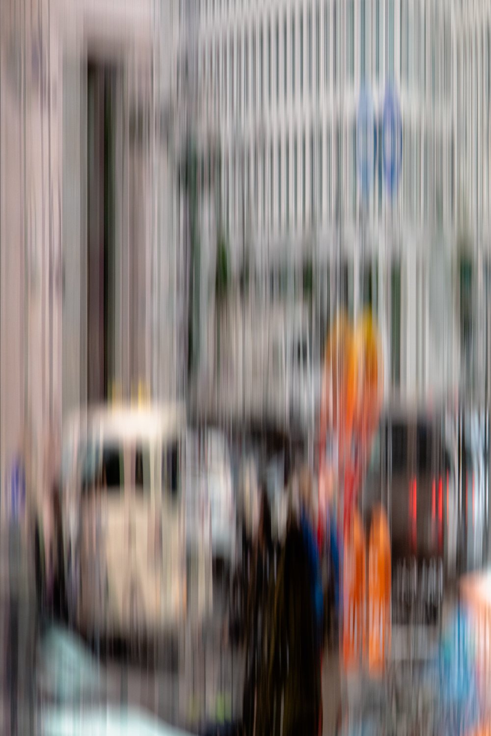 City Life 5, parked cars and an orange marker on a street of tall facades, softened by movement