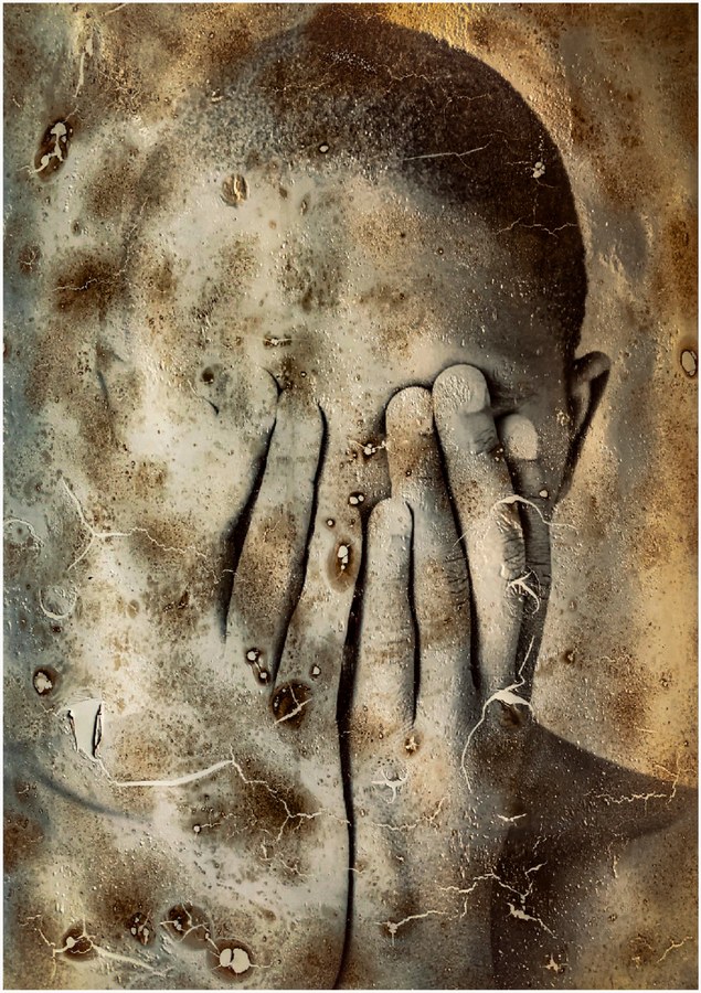 Hands covering a face, worked with heat and emulsion