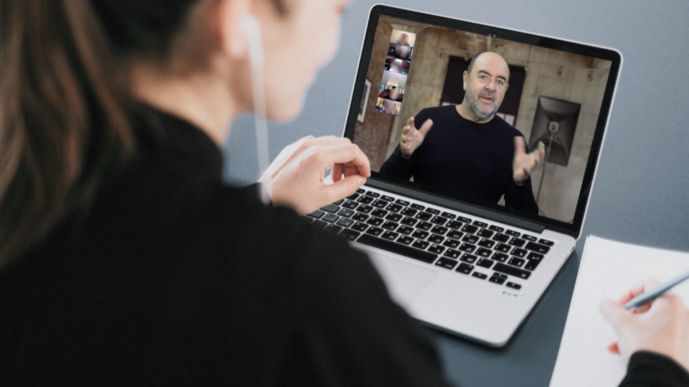 A photographer taking notes during a one to one Zoom lesson with Martin Osner on a laptop screen
