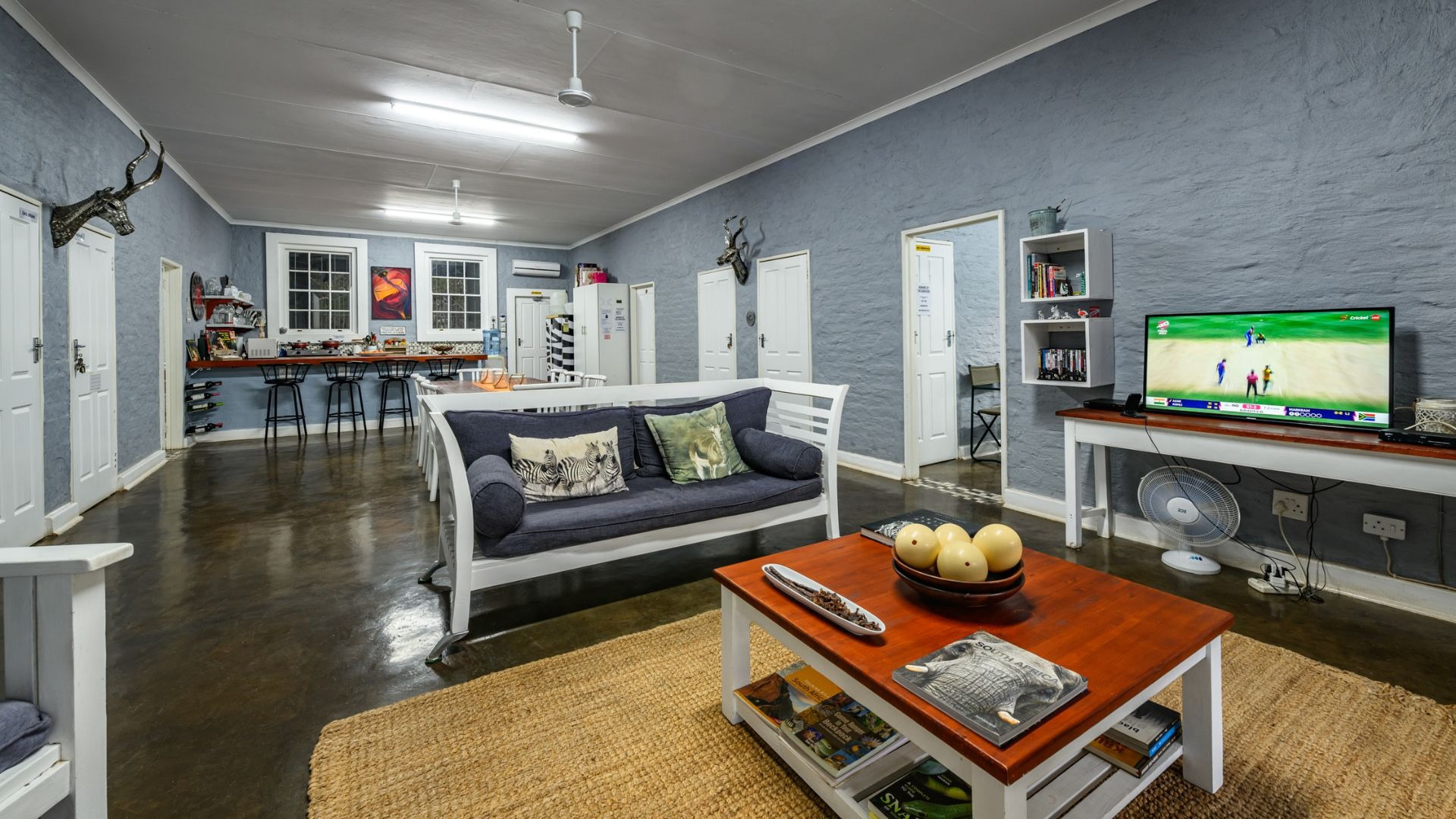 The shared lounge with a blue sofa and a wooden coffee table