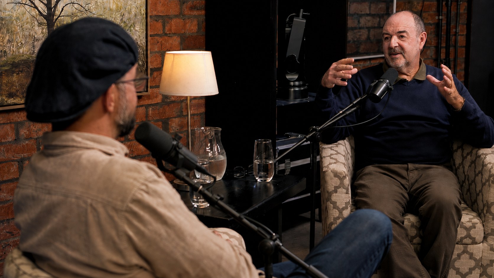 Martin Osner in conversation with a guest during an Open Mic session