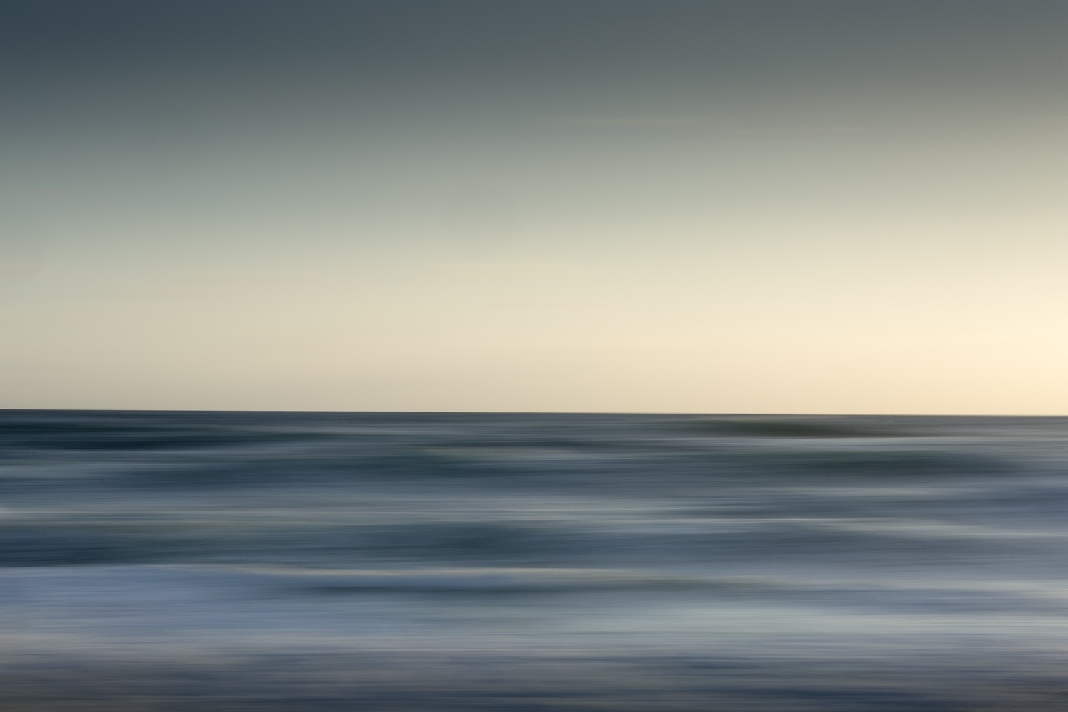 Abstract seascape of horizontal bands of sea and sky made with camera movement