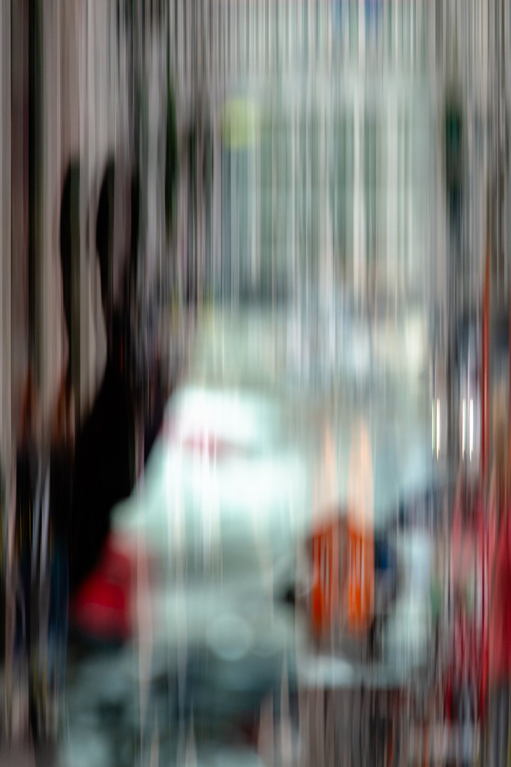 City Life 4, a pale car and passing figures half dissolved among the buildings