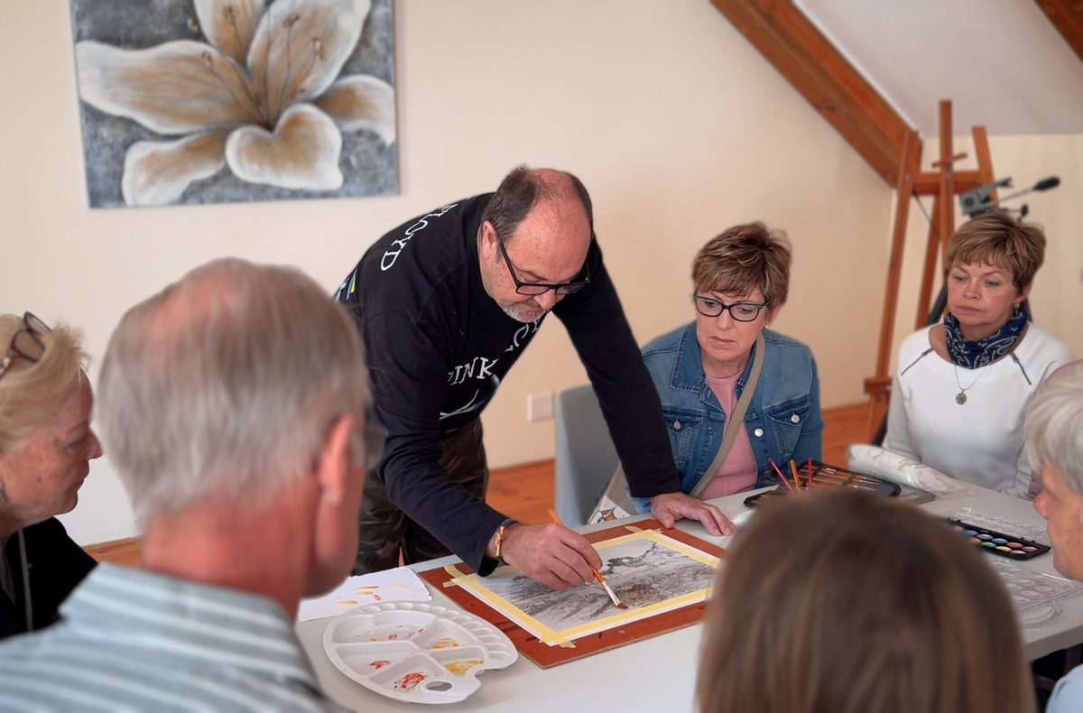 Martin working with students on their pieces at the studio table