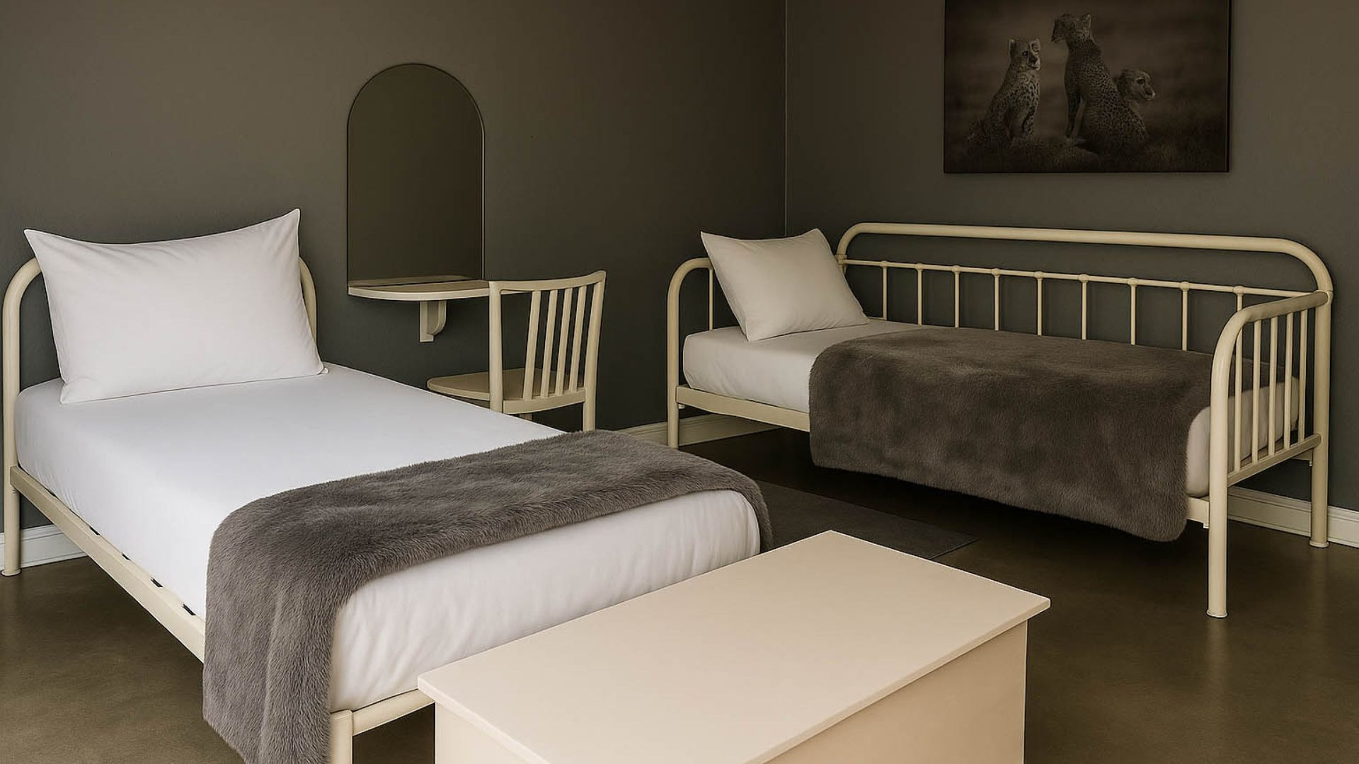 A twin bedroom with white iron beds