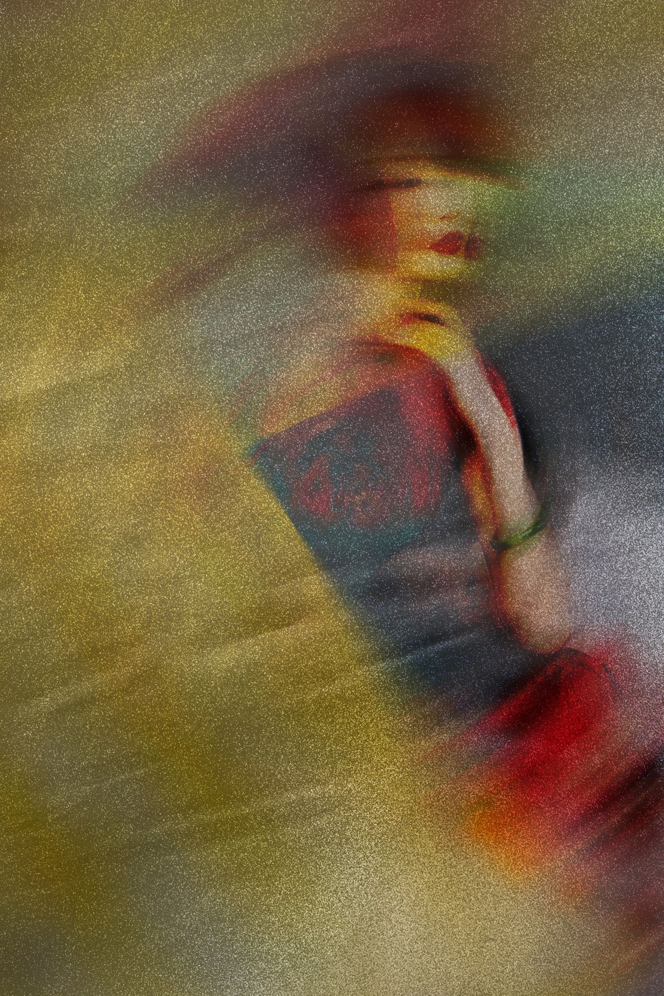 A seated figure in gold, rust and deep red, blurred into the surface, from A Veil of Colour