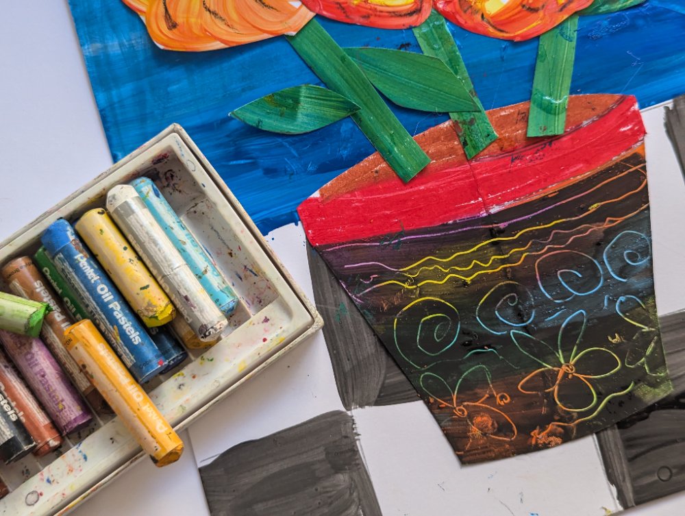 A scratch-art flower pot with swirling rainbow lines