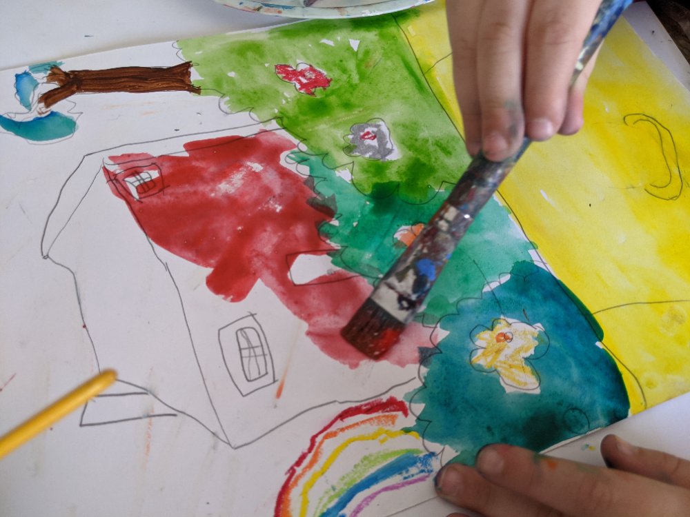 A watercolour house, garden and rainbow