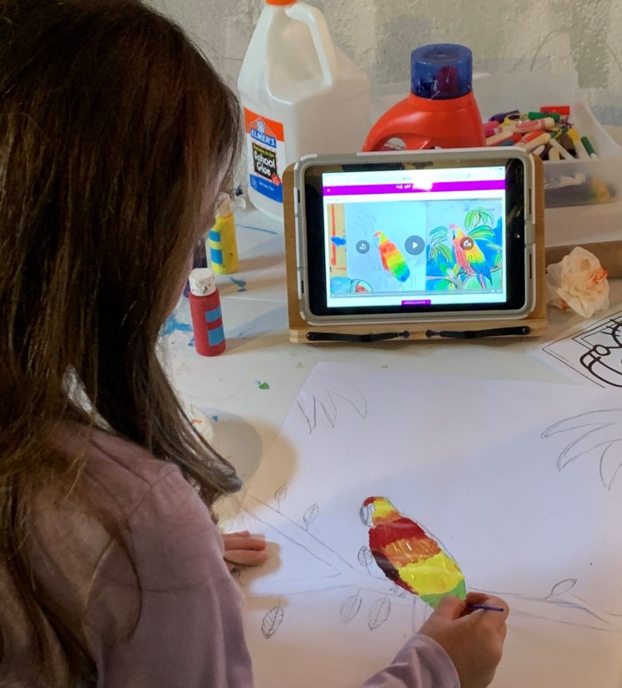 A child following a self-paced Let'sArtit lesson at the kitchen table